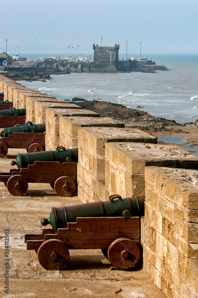 The sun rises over a row of cannons at the former fortress at Essaouira in Morocco. The present city of Essaouira was built facing the Atlantic Ocean. The sun rises over a row of cannons at the former fortress at Essaouira in Morocco. The present city of Essaouira was built facing the Atlantic Ocean.