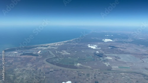 Aerial view from a jet cockpit of Doñana National Park and the Guadalquivir river mouth in Cadiz, Spain, taken at 5000 metres high. 4k photo