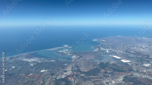 Aerial view of the spanish city and bay of Cadiz  at 5000 metres high with a deep blue sky and daylight. taken from a jet cockpit.  4k photo