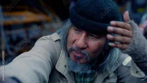4K, Poverty homeless man with a beard begging for money healthy care, lifestyle aged man witretirement social problem from financial crisis unemployment without family, vagrant tramp man on the street
