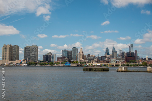 View of Downtown Philadelphia, Peninsulvlenia on a partly cloudy summer day from across the Deleware River.