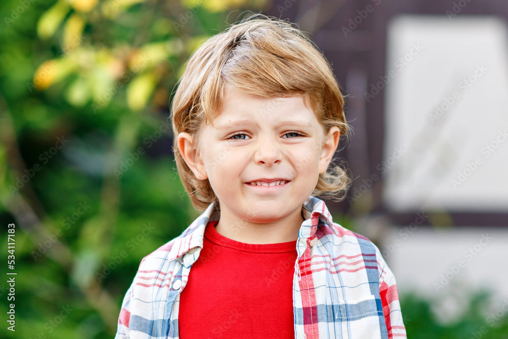 Portrait of happy cute little kid boy with autumn leaves background in colorful clothing. preschool child looking at the camera Portrait of happy cute little kid boy with autumn leaves background in colorful clothing. preschool child looking at the camera