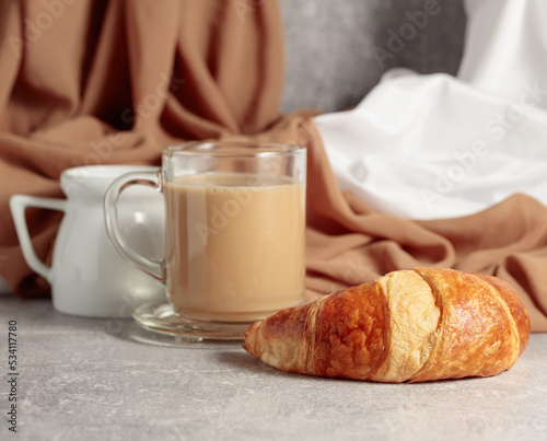 Croissant and coffee with cream.