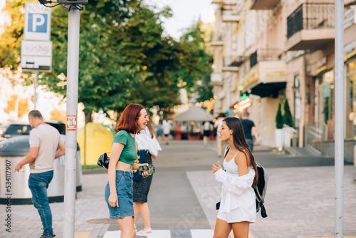 Happy women talking and laughing at the city street © teksomolika