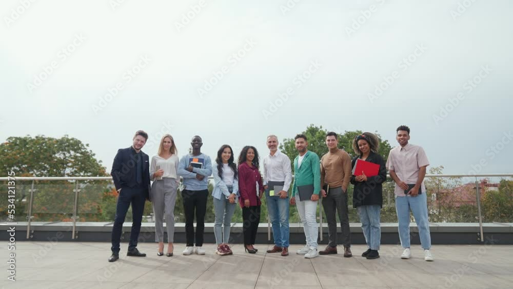 International management team at meeting being on roof of the office building, cheerful colleagues are standing on the roof and looking at the camera, a good deal, a group photo. International management team at meeting being on roof of the office building, cheerful colleagues are standing on the roof and looking at the camera, a good deal, a group photo.