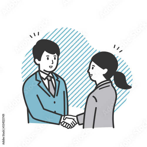 取引先と握手をする働く男女