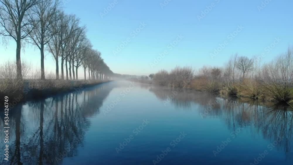Drone shot dolly forward juste above de water on the Scheldt river next Escanaffles in the morning with smog and nice light Drone shot dolly forward juste above de water on the Scheldt river next Escanaffles in the morning with smog and nice light