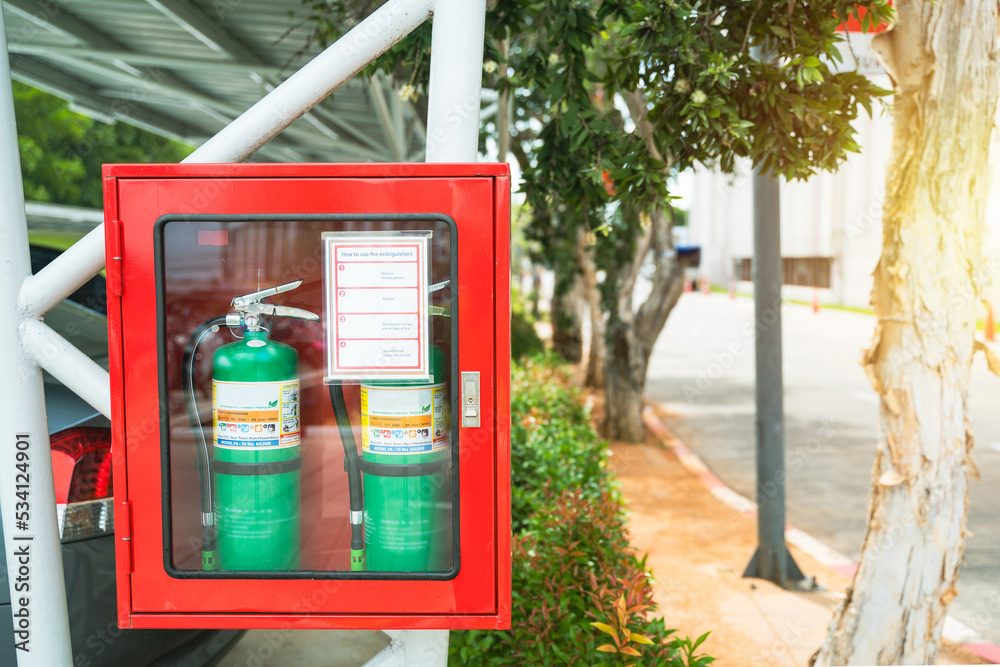 Fire Extinguisher in red cabinet at exterior buildings. Fire Extinguisher in red cabinet at exterior buildings.
