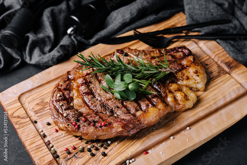 Beef rump steak on black stone table photo