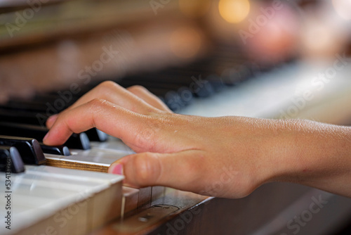 little pianist plays the piano with his right hand, horizontal