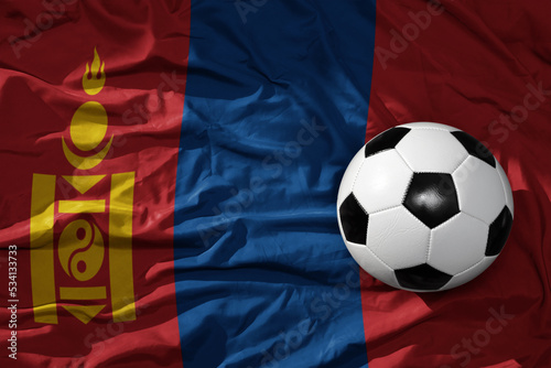 vintage football ball on the waveing national flag of mongolia background. 3D illustration