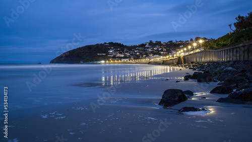 Street lights lit up St Clair beach at dawn, Dunedin. photo