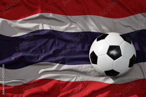 vintage football ball on the waveing national flag of thailand background. 3D illustration