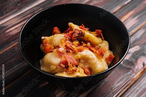 Baked potato dumplings with fried bacon and green onions