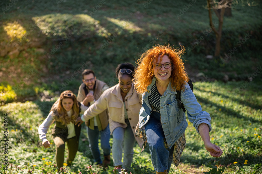 Group of friends holding hands and hiking. Multietnical group of people Group of friends holding hands and hiking. Multietnical group of people