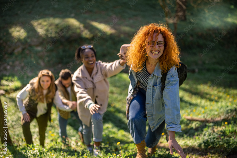 Group of friends holding hands and hiking. Multietnical group of people Group of friends holding hands and hiking. Multietnical group of people