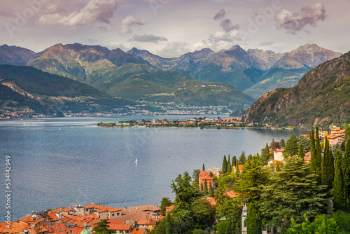 Village and sailboats on Lake Como near Bellagio at sunset, Italy