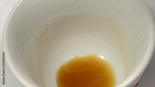 Vietnamese fish sauce running into a bowl