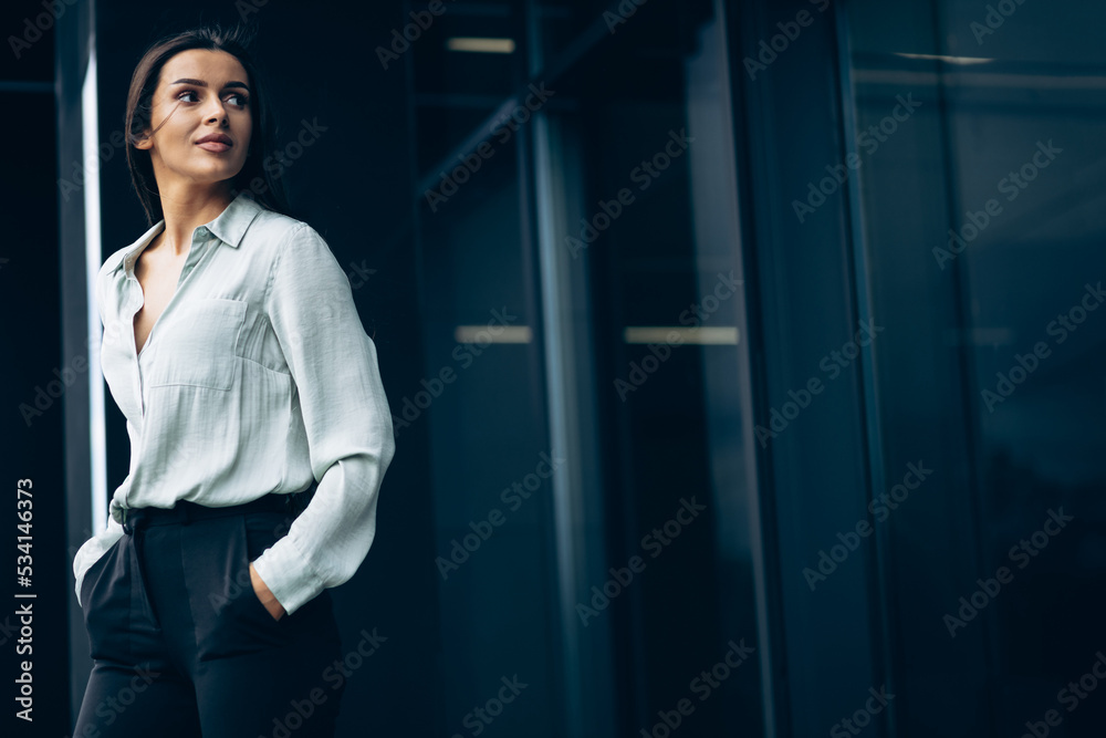 Fototapeta premium Business woman standing by the office building