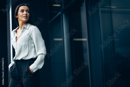Business woman standing by the office building