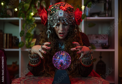 sorceress with a surprised face when she sees lightning bolts in her fortune-telling crystal ball © victor