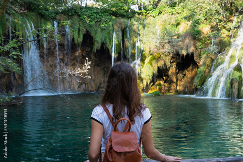 woman and a waterfall in Plitvice lakes national park