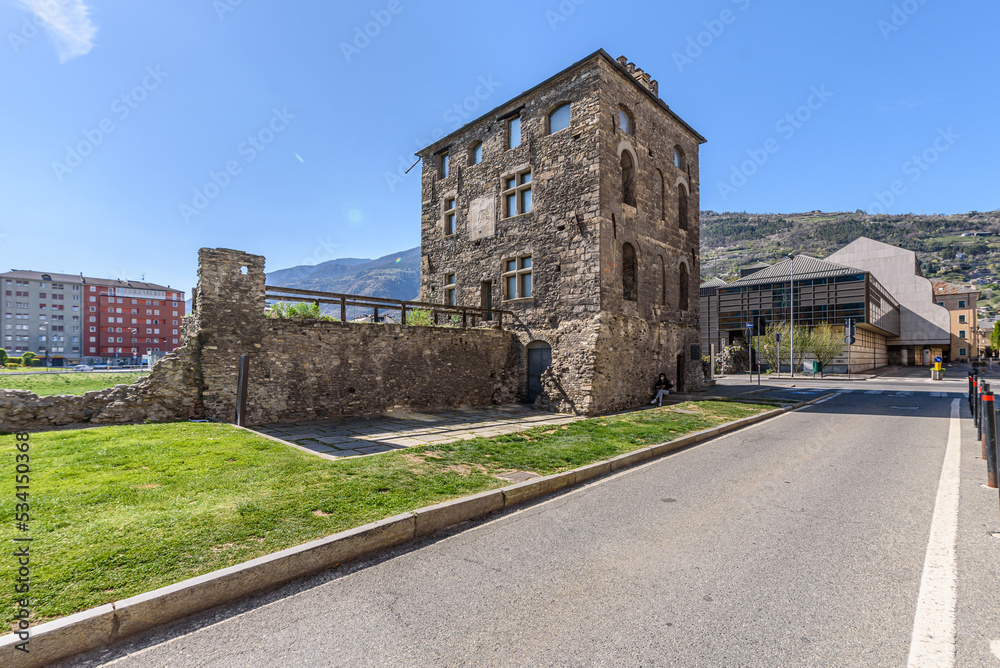 Aosta, Italy. View of the ancient Roman tower called Torre del Lebbroso (Tower of the Leper), located at the corner of Via Festaz and Via Tour de Lepreux. April 17, 2022.
