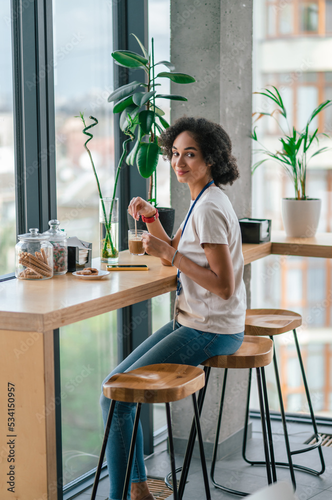 Young pretty office worker in the office canteen