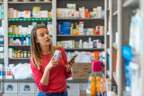 Mid adult female customer choosing product at pharmacy. Everything I need here. Portrait of a beautiful female pharmacy customer. Female customer selecting products in drugstore.