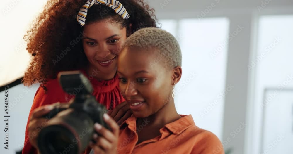 Photography, art and photoshoot in a creative studio with a black model for a magazine or campaign. African photographer and woman analyzing pictures together on a dslr camera on set in south africa. Photography, art and photoshoot in a creative studio with a black model for a magazine or campaign. African photographer and woman analyzing pictures together on a dslr camera on set in south africa.
