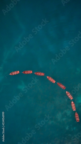 red boats in blue lake photo