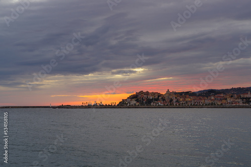 Clouds at sunset with Imperia cityscape  Liguria region  Italy