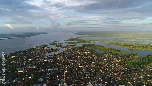 Drone take aerial view of the Parintins city from a great height on a cloudy day in Amazonas, Brazil photo