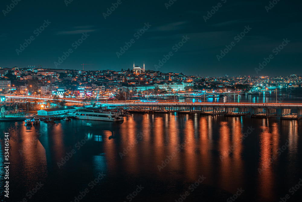 Cityscape view at night of Istanbul city and Bosphorus strait 
