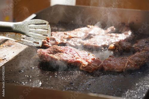 Roasting different pieces of beef for burgers and quesadillas.