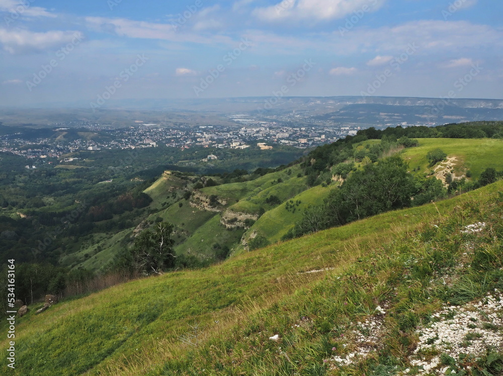 Fototapeta premium Panoramic views from Bolshoye Sedlo mountain to the Kislovodsk National Park and the city of Kislovodsk, North Caucasus, Russia.