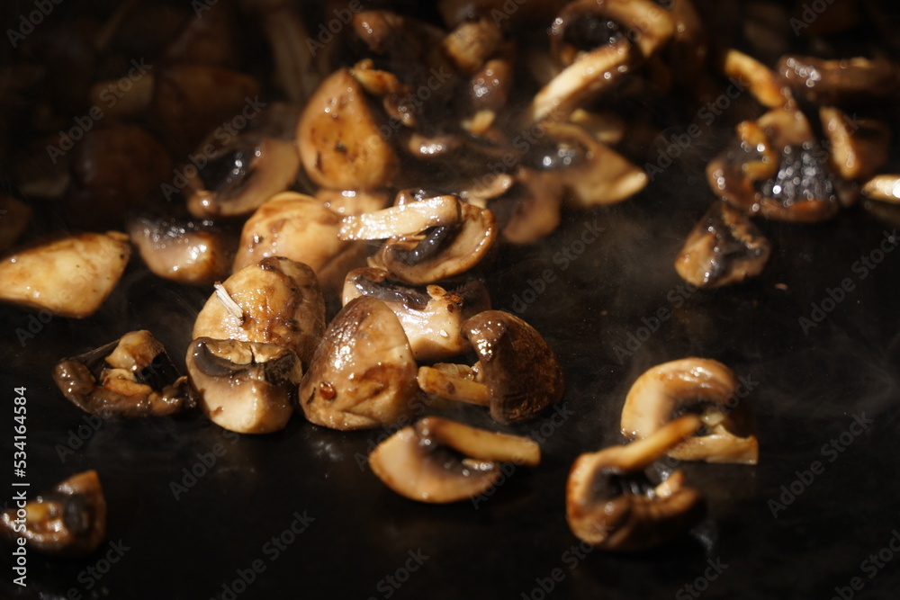 Roasting mushrooms on an open outdoor flat plate. Roasting mushrooms on an open outdoor flat plate.