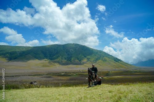 Malang Indonesia 29 September 2022 : Local Childern ride a horse in Savannah Bromo mountain photo