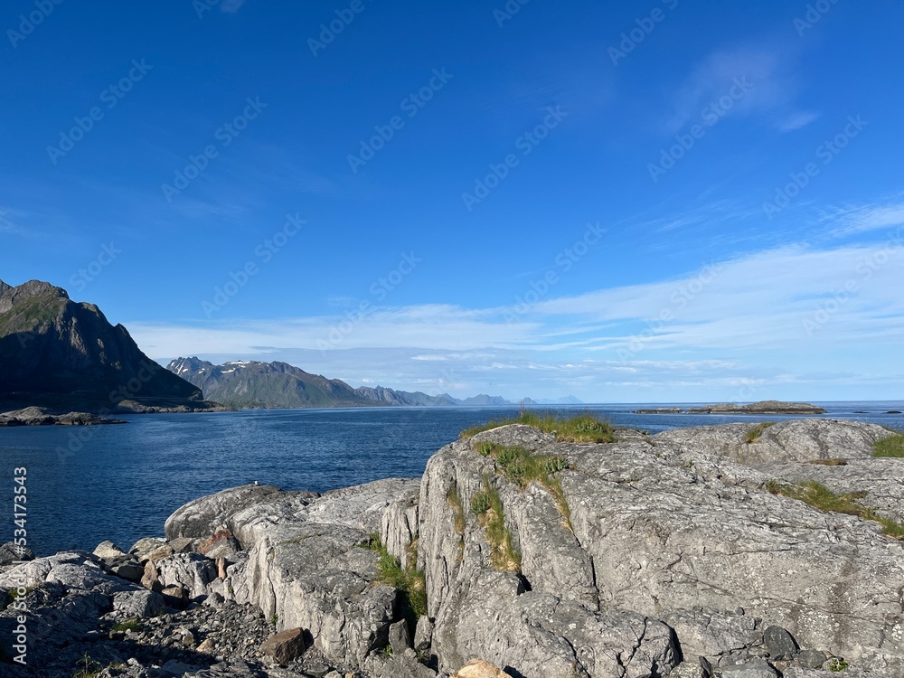 ocean blue horizon, ocean surface, rocky coastline of the fjord