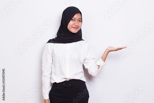 young asian muslim business woman pointing with fingers to different directions isolated on white background
