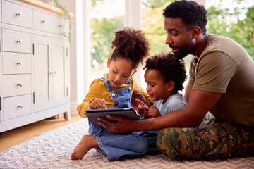 Army Father In Uniform Home On Leave With Children Using Digital Tablet