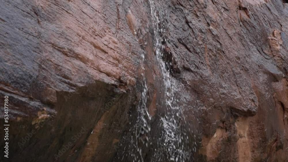 small waterfall between sandstone boulders small waterfall between sandstone boulders