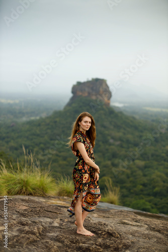 Blonde and beautiful tourist woman at Sigiriya Rock photo