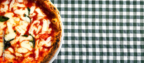 Margherita pizza is a traditional Italian dish. Sauce, mozzarella and basil are ingredients that create a unique taste. The concept of Italian street food. Top view. Copy space. Banner