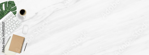 Flat lay work desk table with computer , book , coffee on marble texture background include empty space for product or text graphic advertise