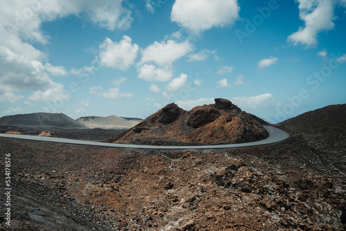 Road in volcanic arid landscape of Timanfaya National Park, Lanzarote, Canary Islands, Spain