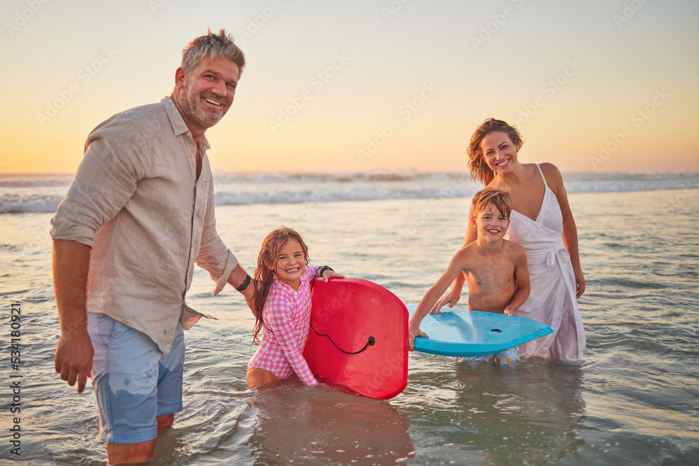 Fototapeta premium Family, beach and body board, kids with parents in water on summer holiday. Mom, dad and children surfing in ocean at sunset in Australia. Freedom, fun and vacation, happy man and woman play in waves