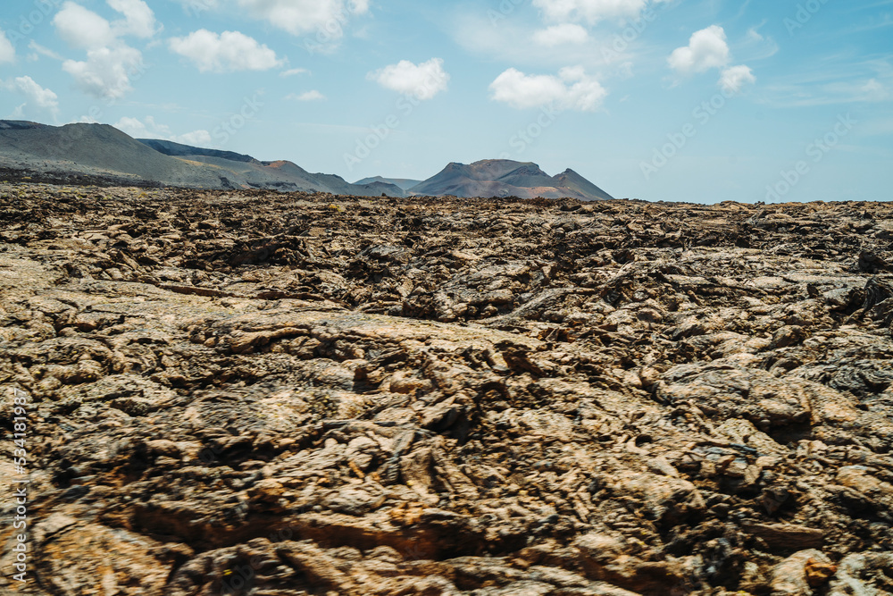 Obraz premium Arid volcanic landscape with lava fields in Timanfaya National Park, Lanzarote, Canary Island, Spain