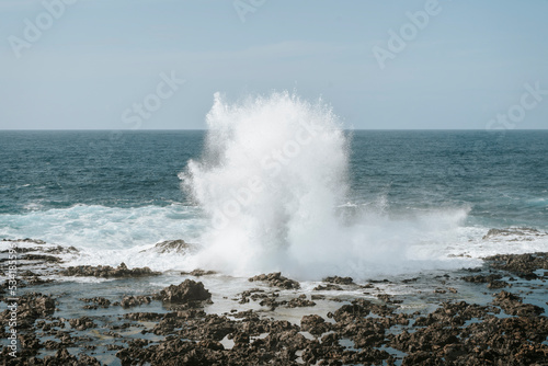 Water splash on black volcanic rocks of Tenesar, Lanzarote, Canary Islands