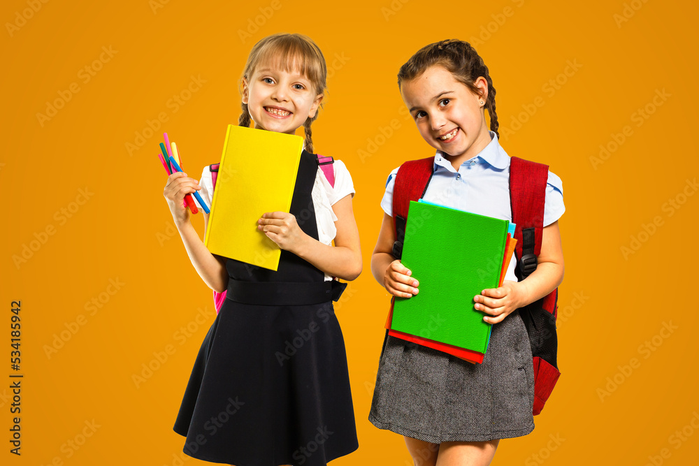 Little girls with books on orange background Little girls with books on orange background